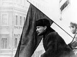 V.I Lenin giving a speech to demonstrating workers and soldiers.