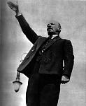V. I. Lenin making a speech from a rostrum in the Red Square on May Day, the day of international celebration.